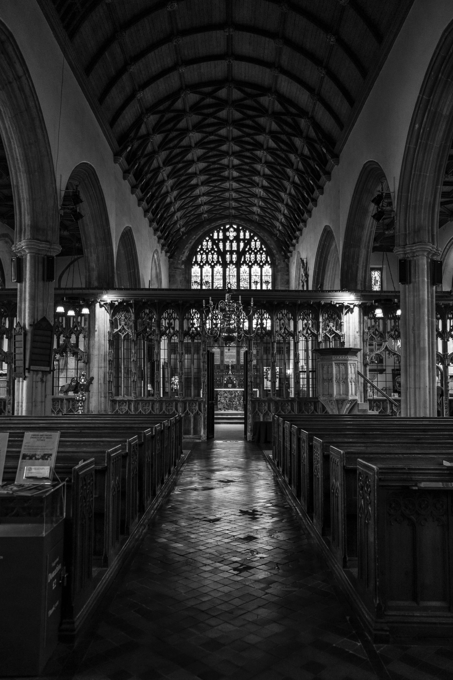 the inside of an old church, with pews lined up in rows