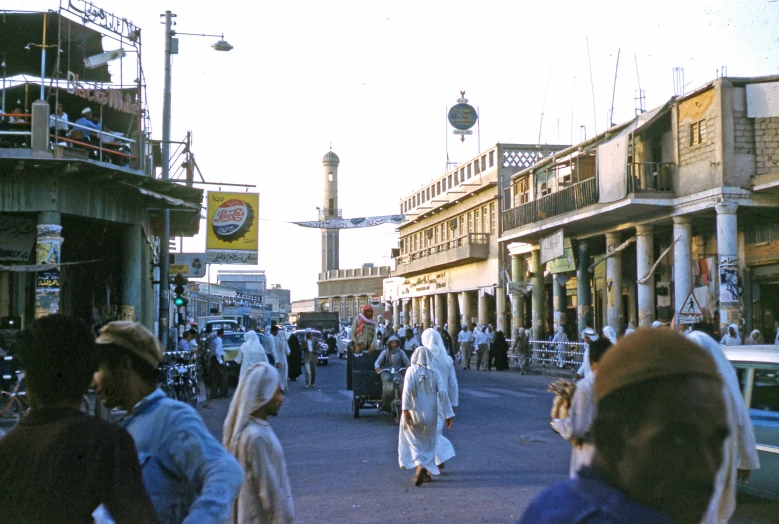 many people are walking down the busy street