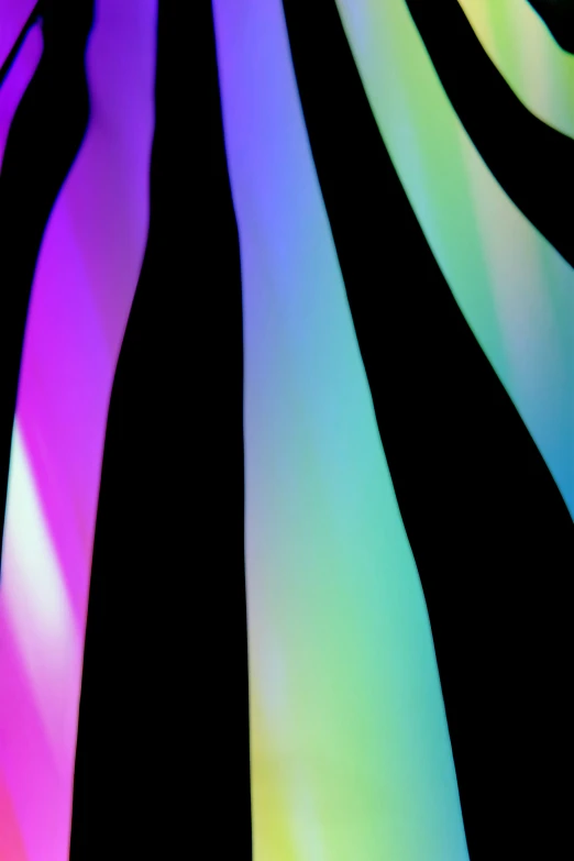 a close up s of a black background with multi - colored stripes