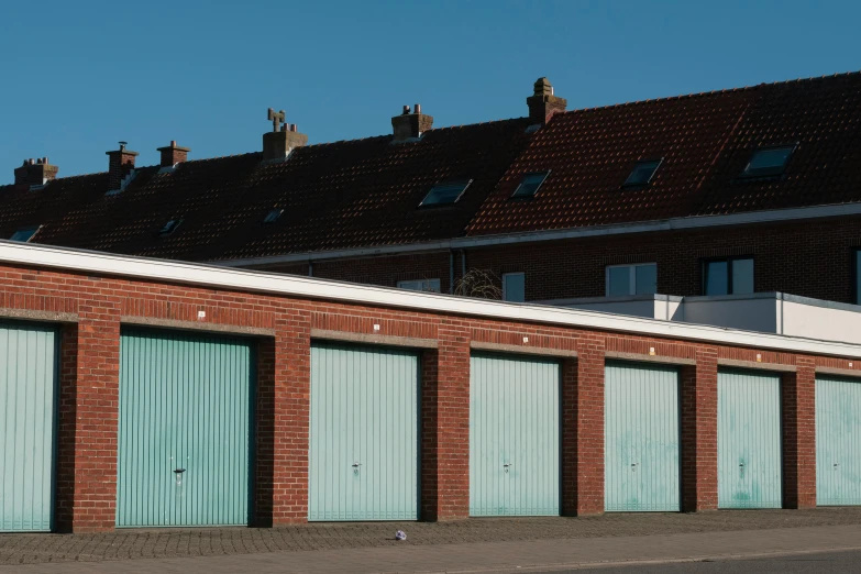 an older brick building with many blue doors