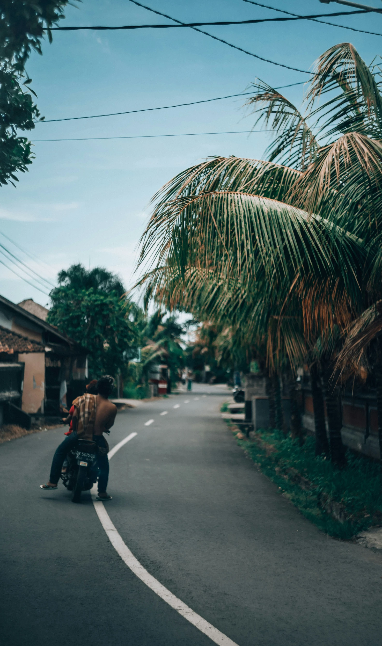 the young man is riding his motorcycle down the street