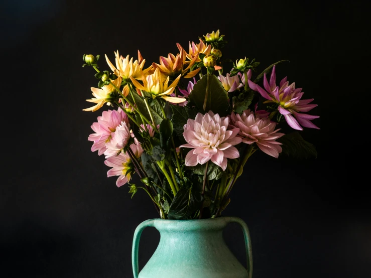 a vase filled with lots of colorful flowers