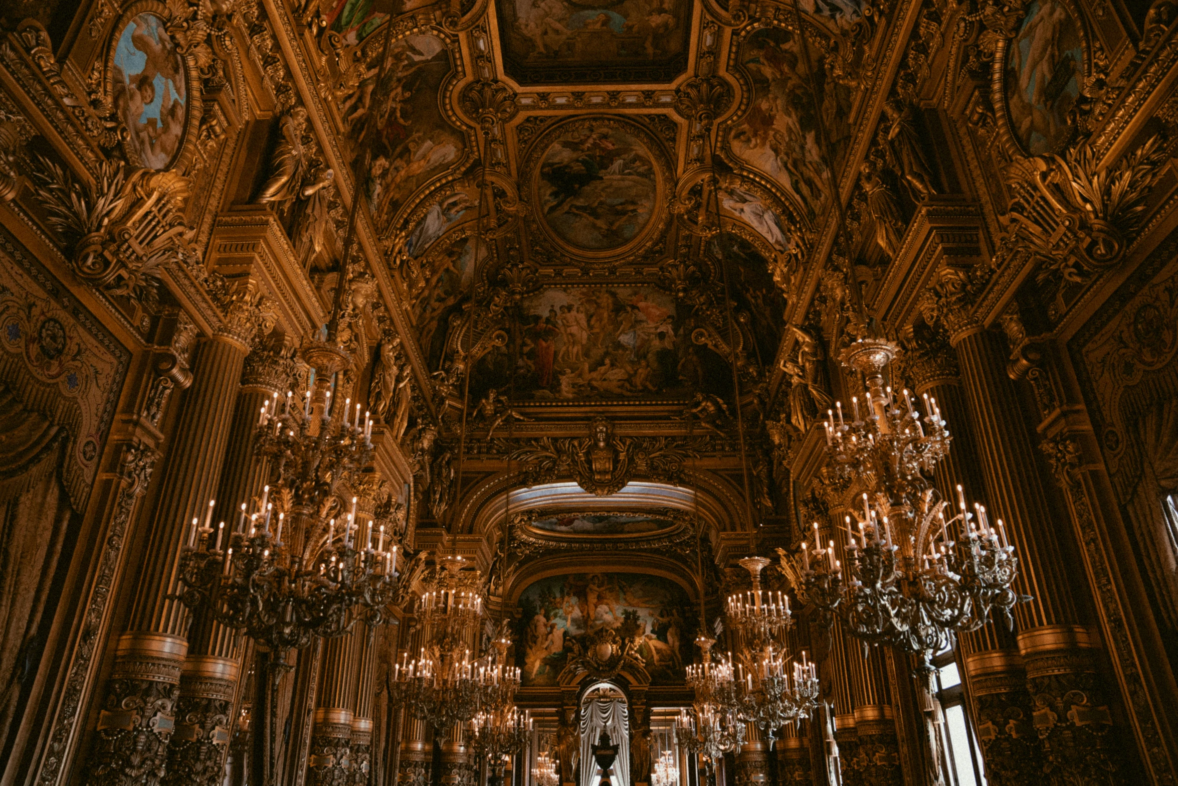 fancyly ornately decorated room with chandeliers and elaborate ceiling