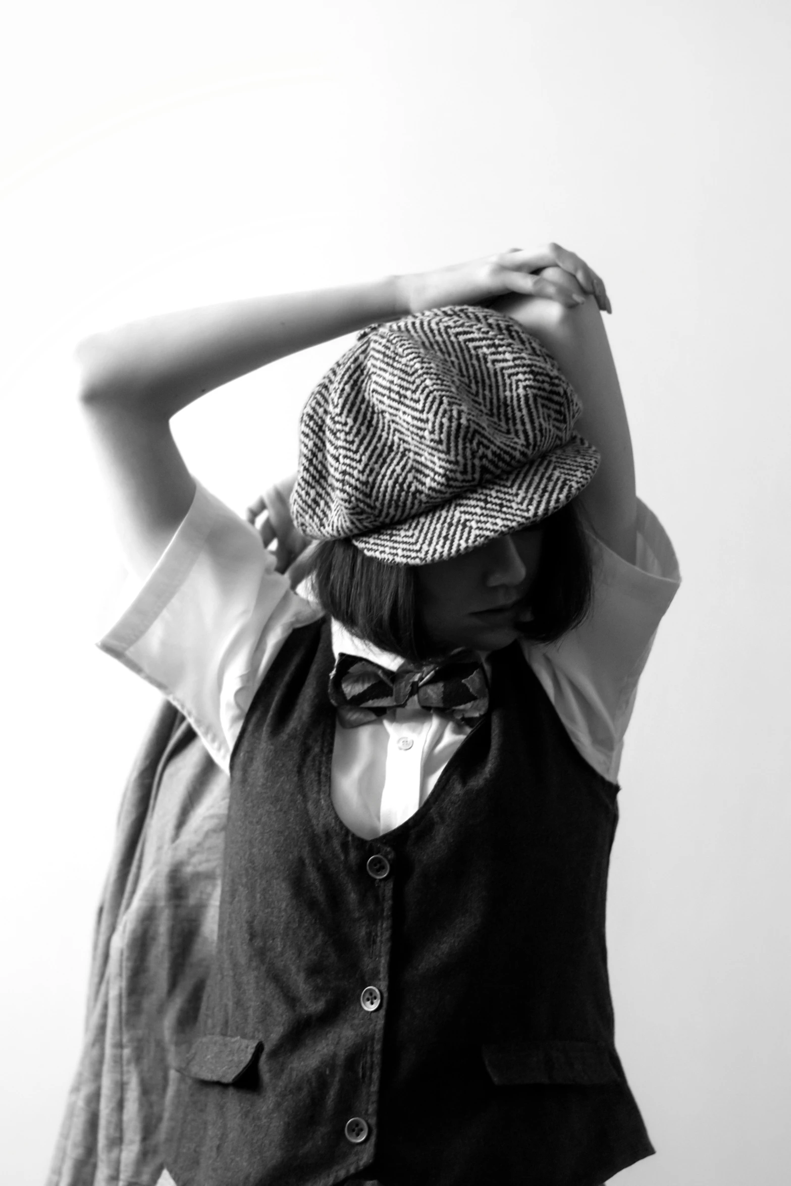 woman leaning on wall while wearing shirt and tie