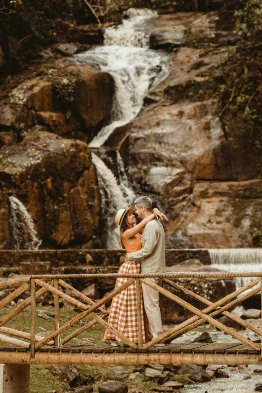 a couple emce as they take in the beautiful waterfall views