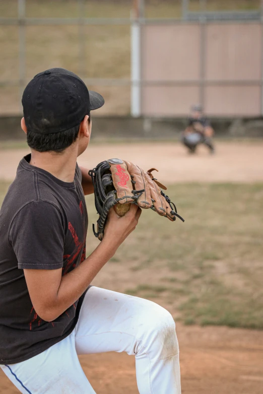 a baseball player wearing a catchers mitt standing on the field