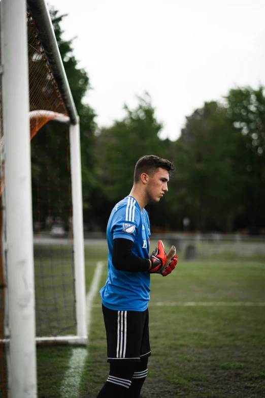 a man is standing near a goalie net