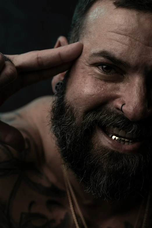 man with beard smiling and piercing around his nose