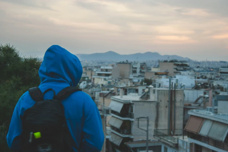 a person is standing with a back pack on top of a city