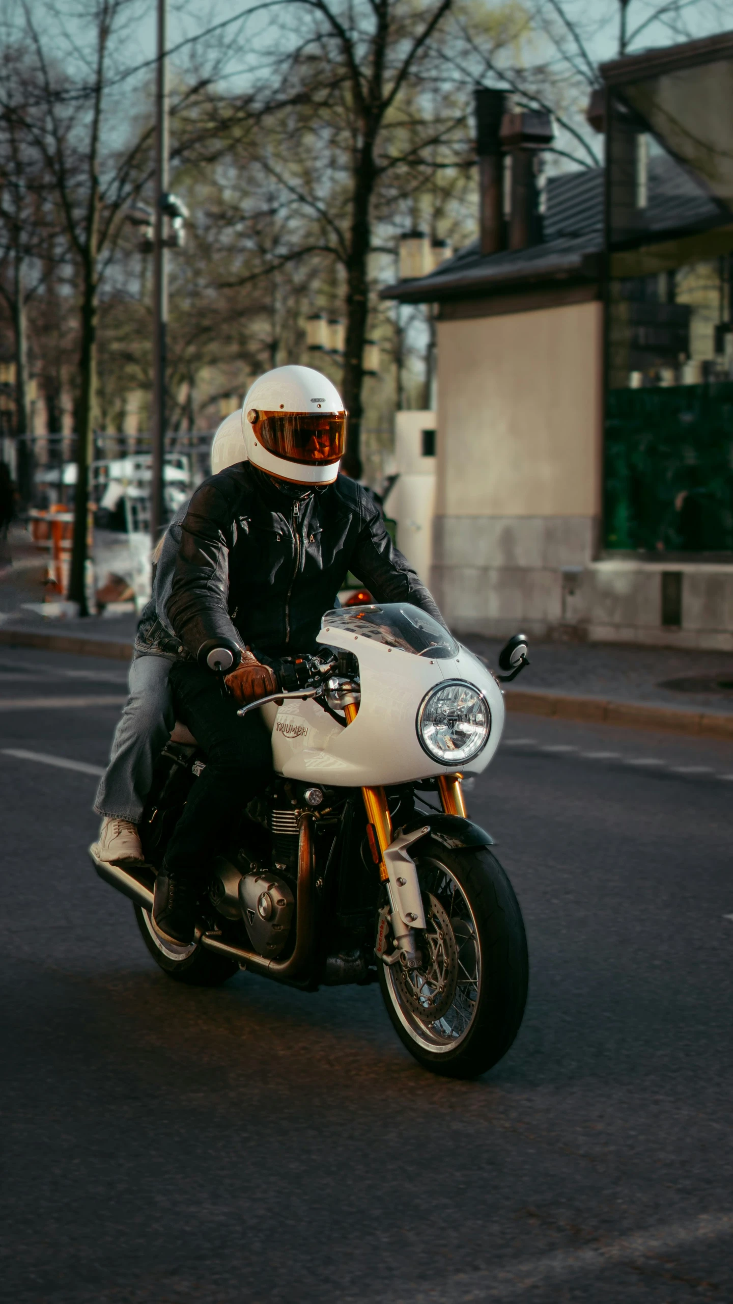 a guy wearing a helmet is riding on his motorcycle