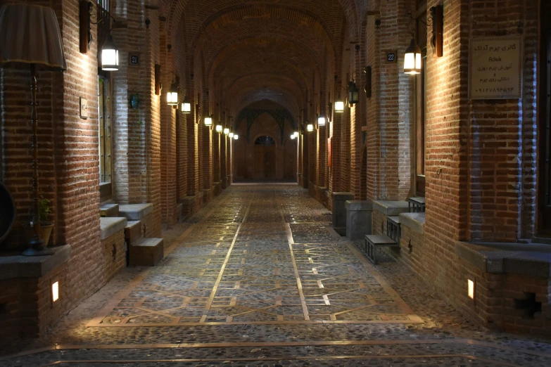 a very long room with lights and benches in it