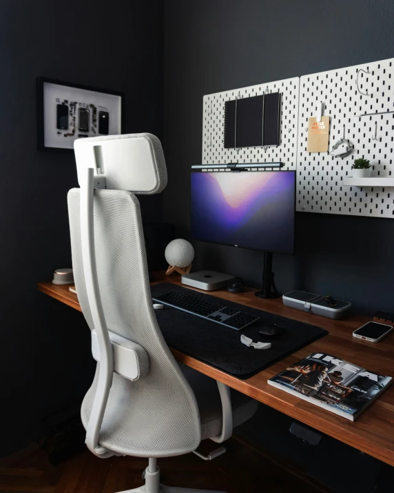 a chair is sitting in front of the desk with two monitors on it