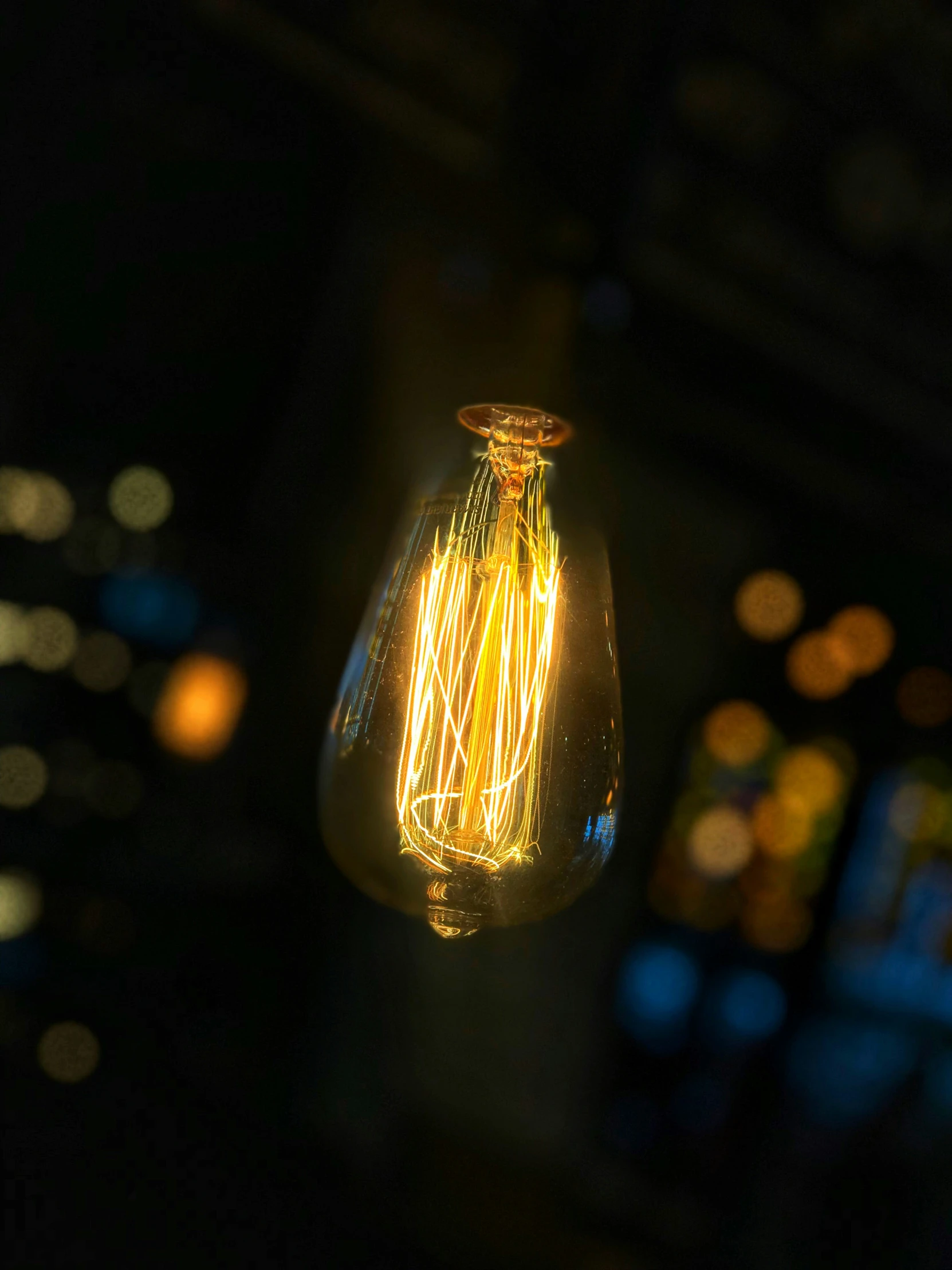 a close up of an old light bulb in the dark