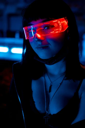 a woman with glowing eye glasses at night