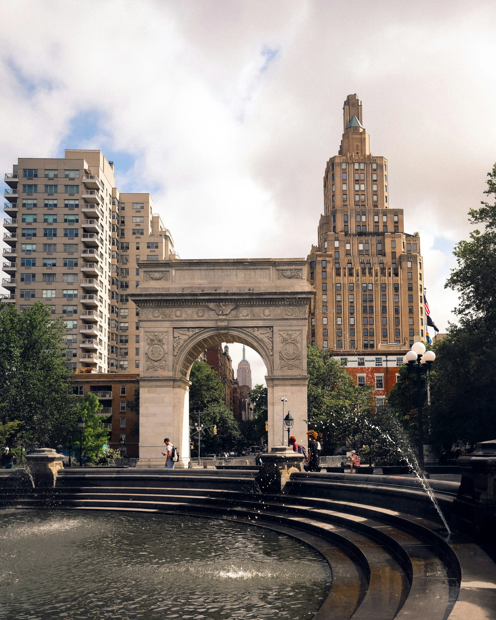 a large arch is in the center of a water feature