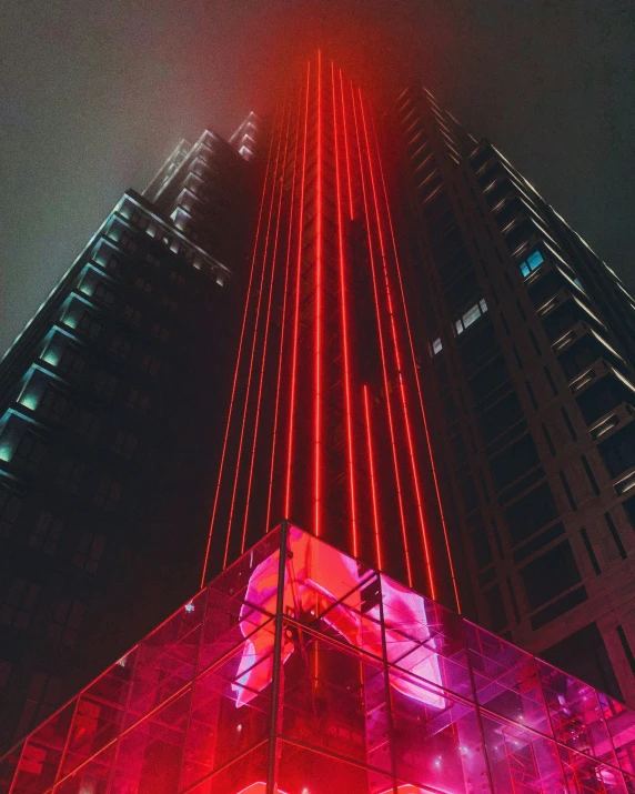 an image of a bright red tower lit up