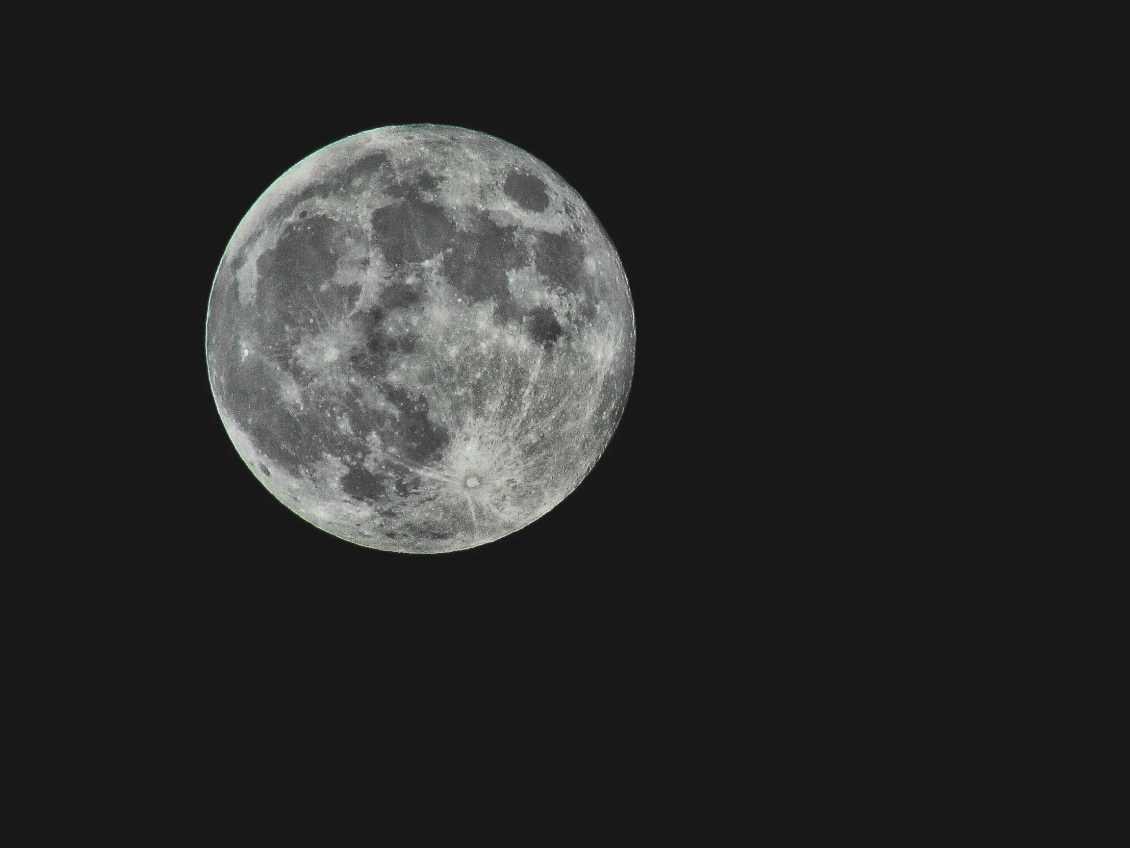 a full moon s through the night sky