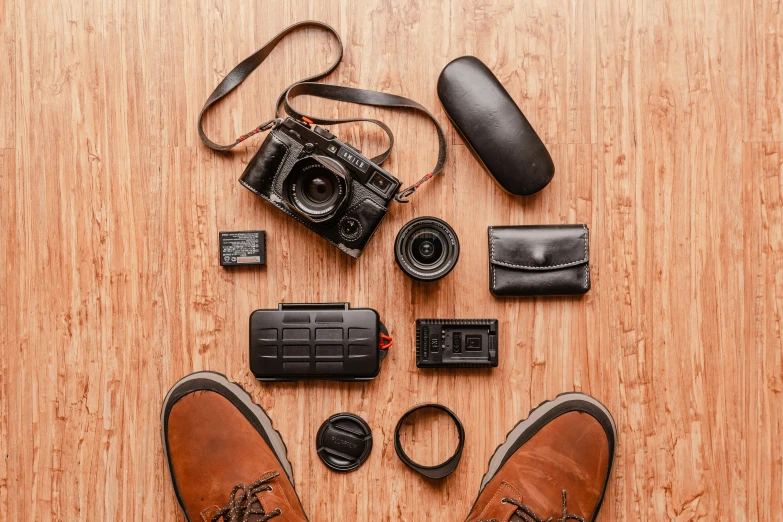 several camera equipment and other electronics laid out on the floor