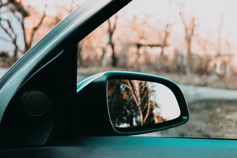 a side view mirror on the dash of a car