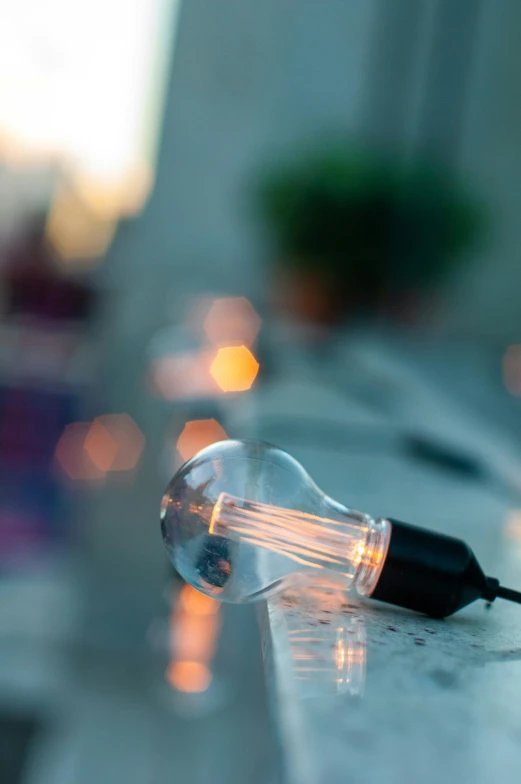 a light bulb sitting on top of a table with small plugs