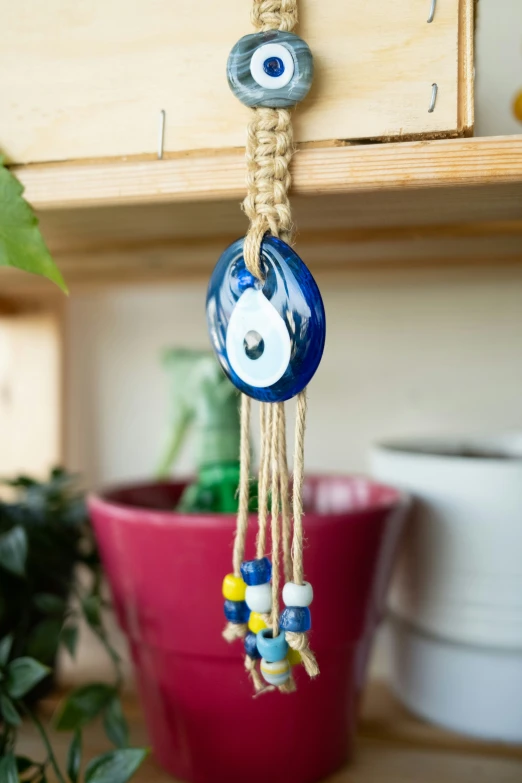 an evil eye bead hanging from a drawer