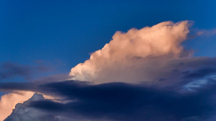 a plane flying very high above a stormy sky