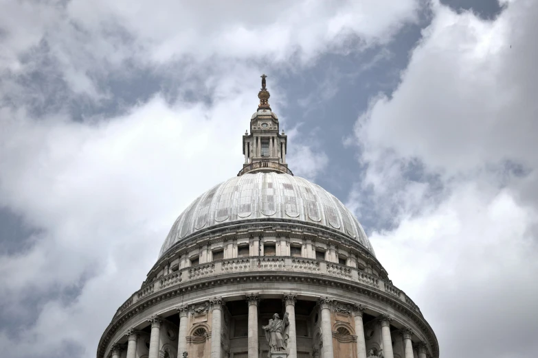 a building with columns and a tower has a steeple