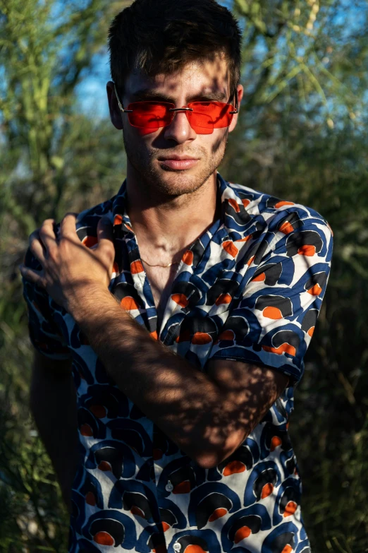 a man with sunglasses posing for a po