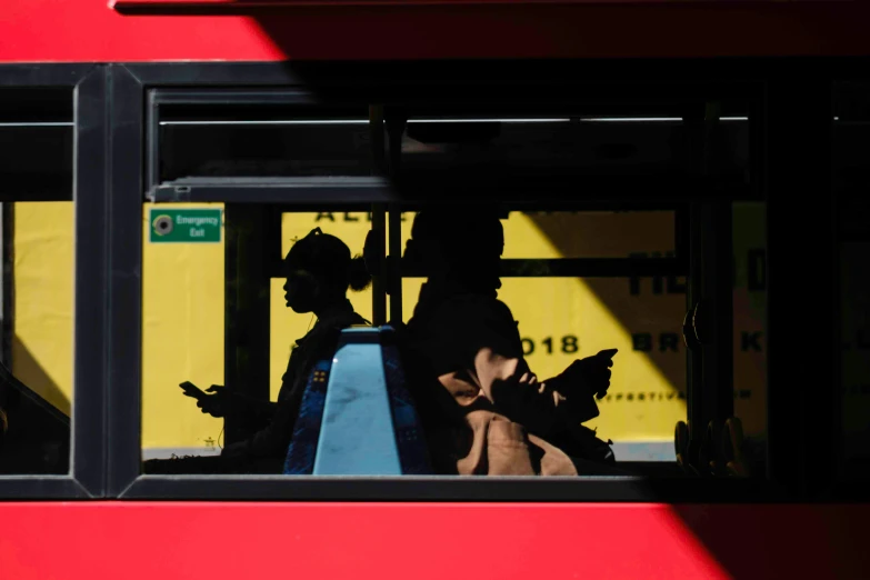 people sitting on a bus looking out the window