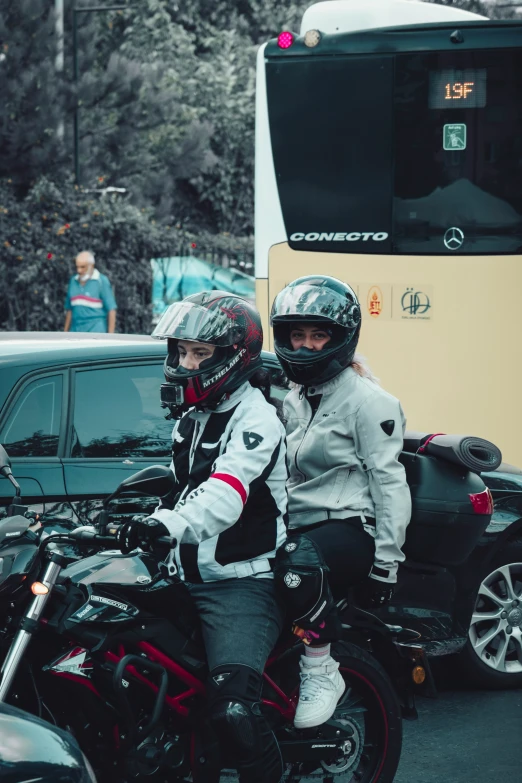 a couple of men sitting on a motorcycle