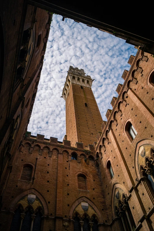 a tower of a building that has the sky behind it