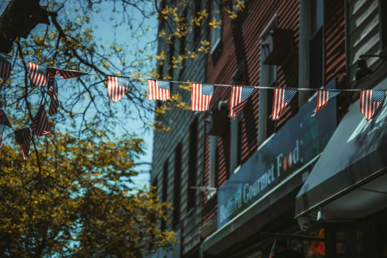 american flags hanging in front of an office building