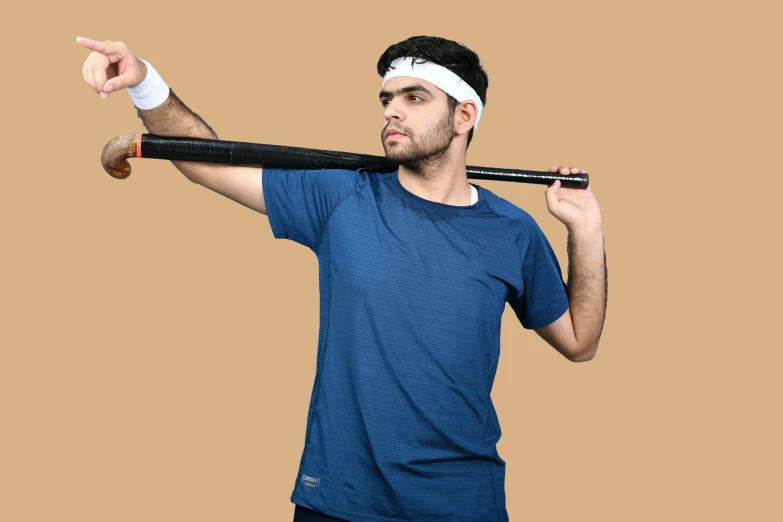 a man is holding a baseball bat in his right hand