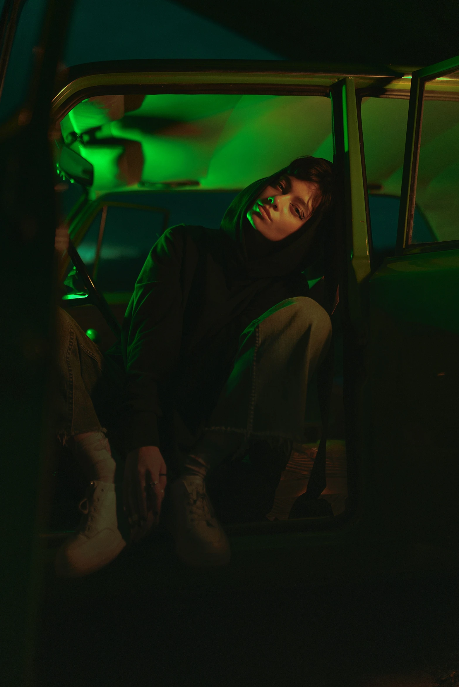 man sitting in the window of an old pickup truck