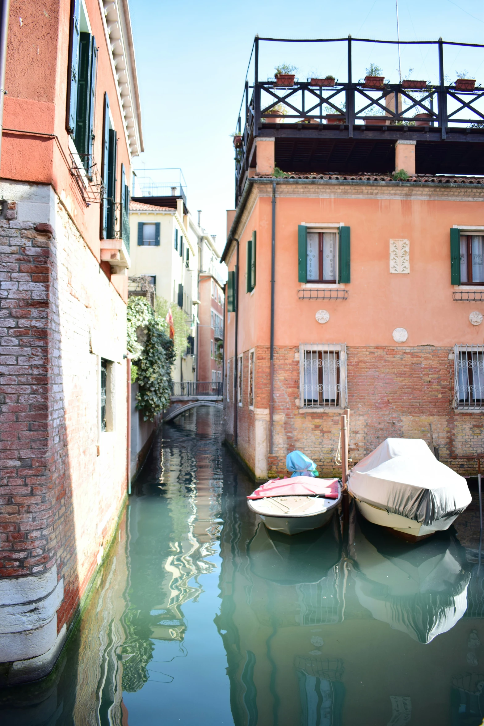 a boat is docked outside a red brick building