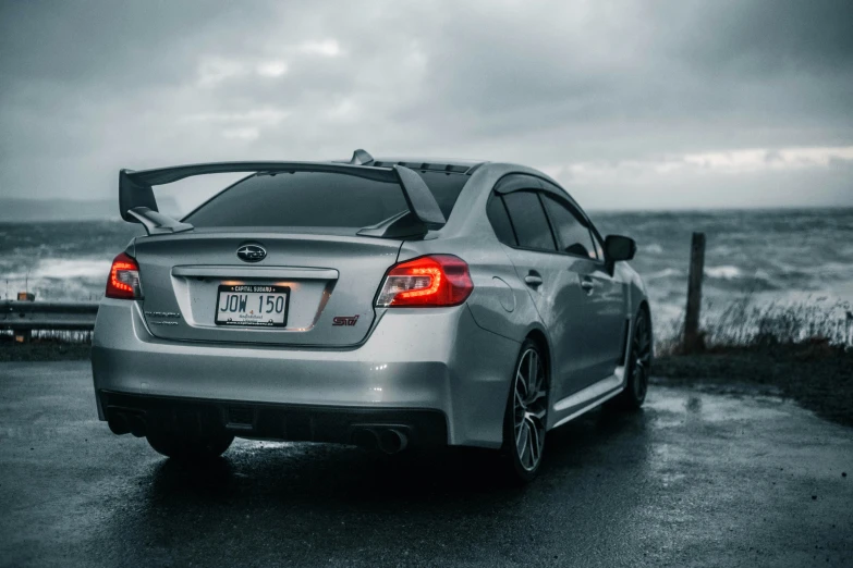 a silver subarun sits on the side of a road