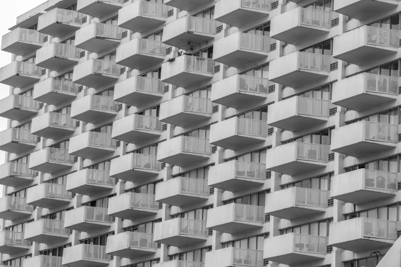 many windows on an apartment building in black and white