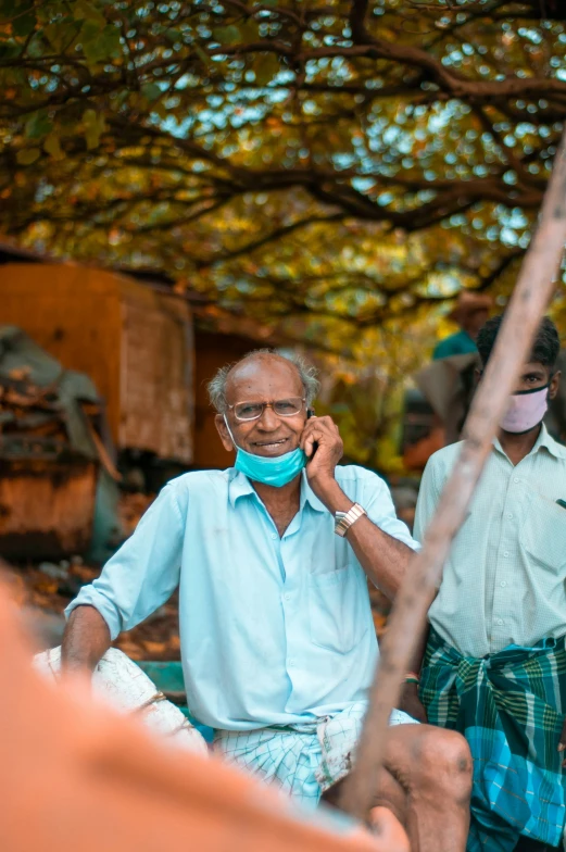 a man wearing a face mask on the phone