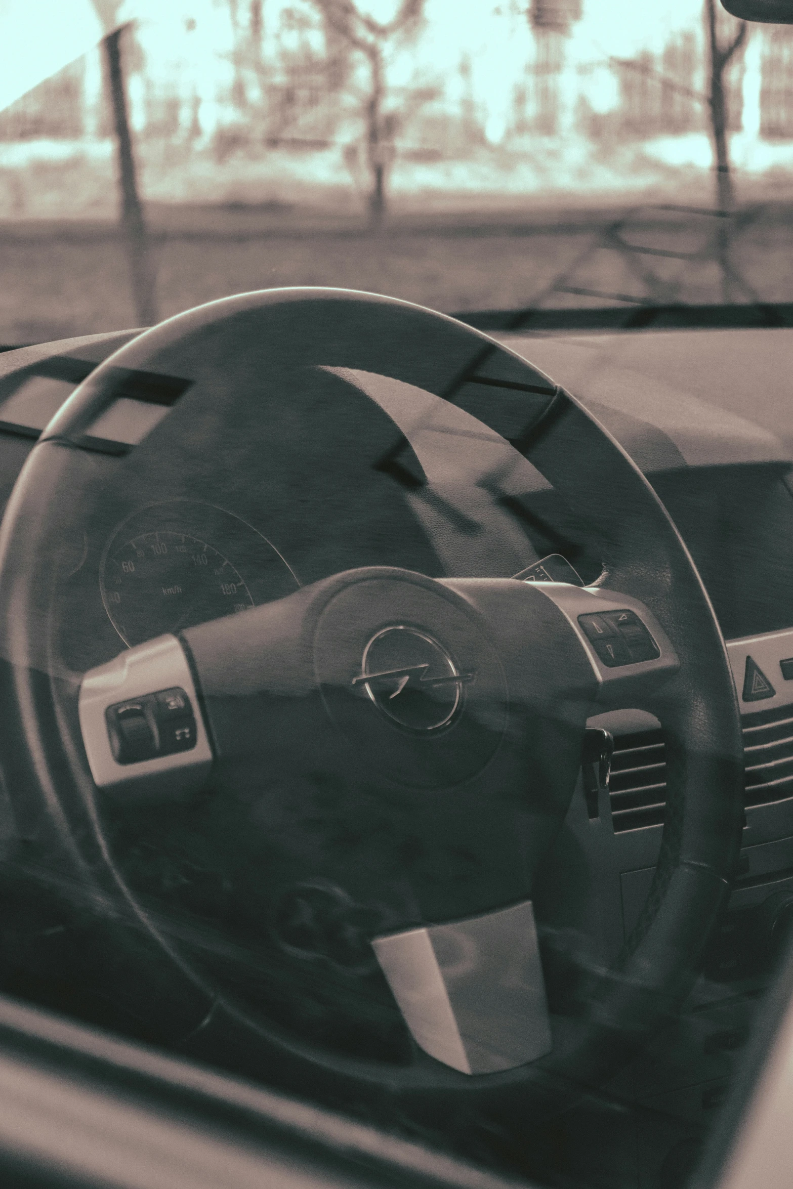 the view of the inside of a car's steering wheel, from inside a vehicle