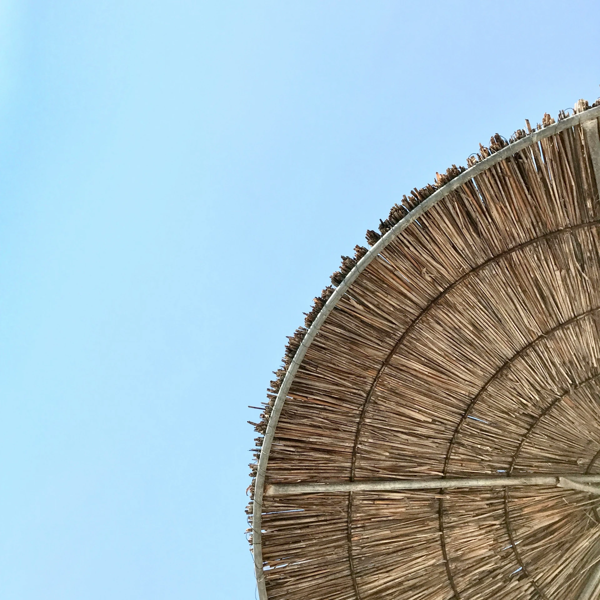 an umbrella with the sky in the background