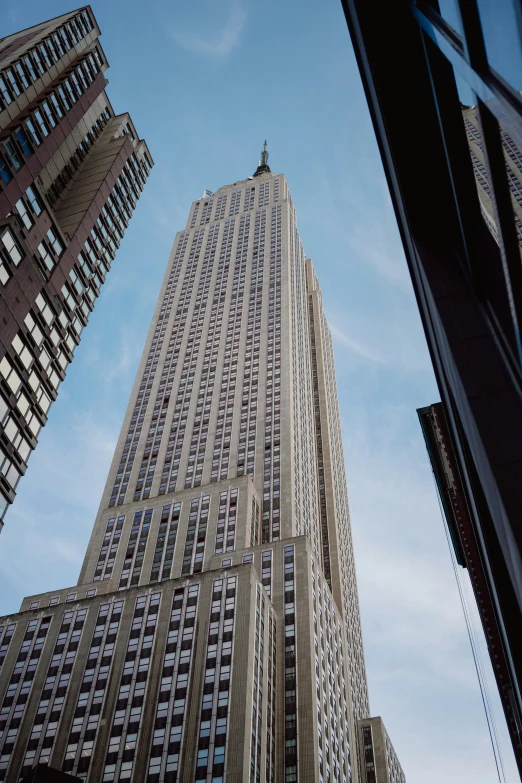 skyscrs line the top of two buildings, while another skyscr stands tall in the background