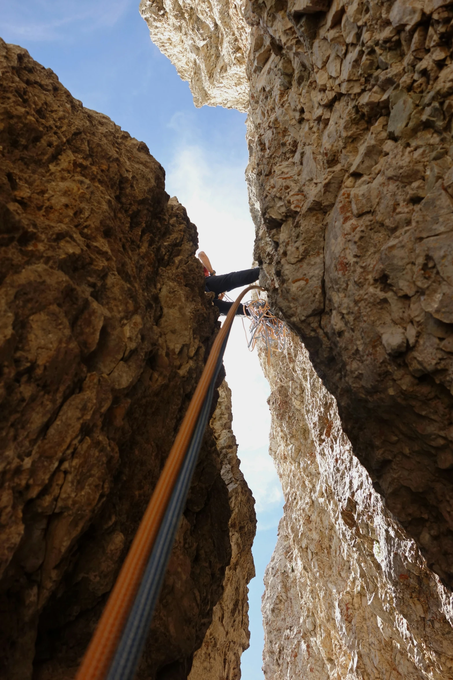 the man is climbing down to a cliff