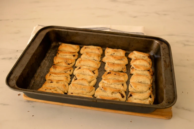 a pan filled with pastry cut into four small squares