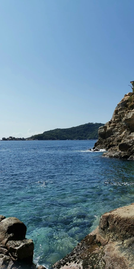 a body of water near some mountains and the ocean