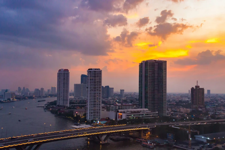 some buildings with a bridge in the middle and sky in the back