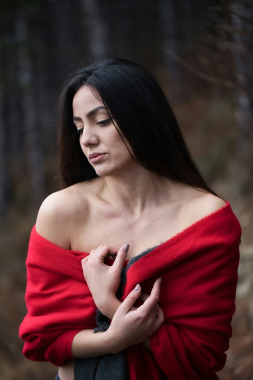 a young woman with long dark hair wearing a red shirt