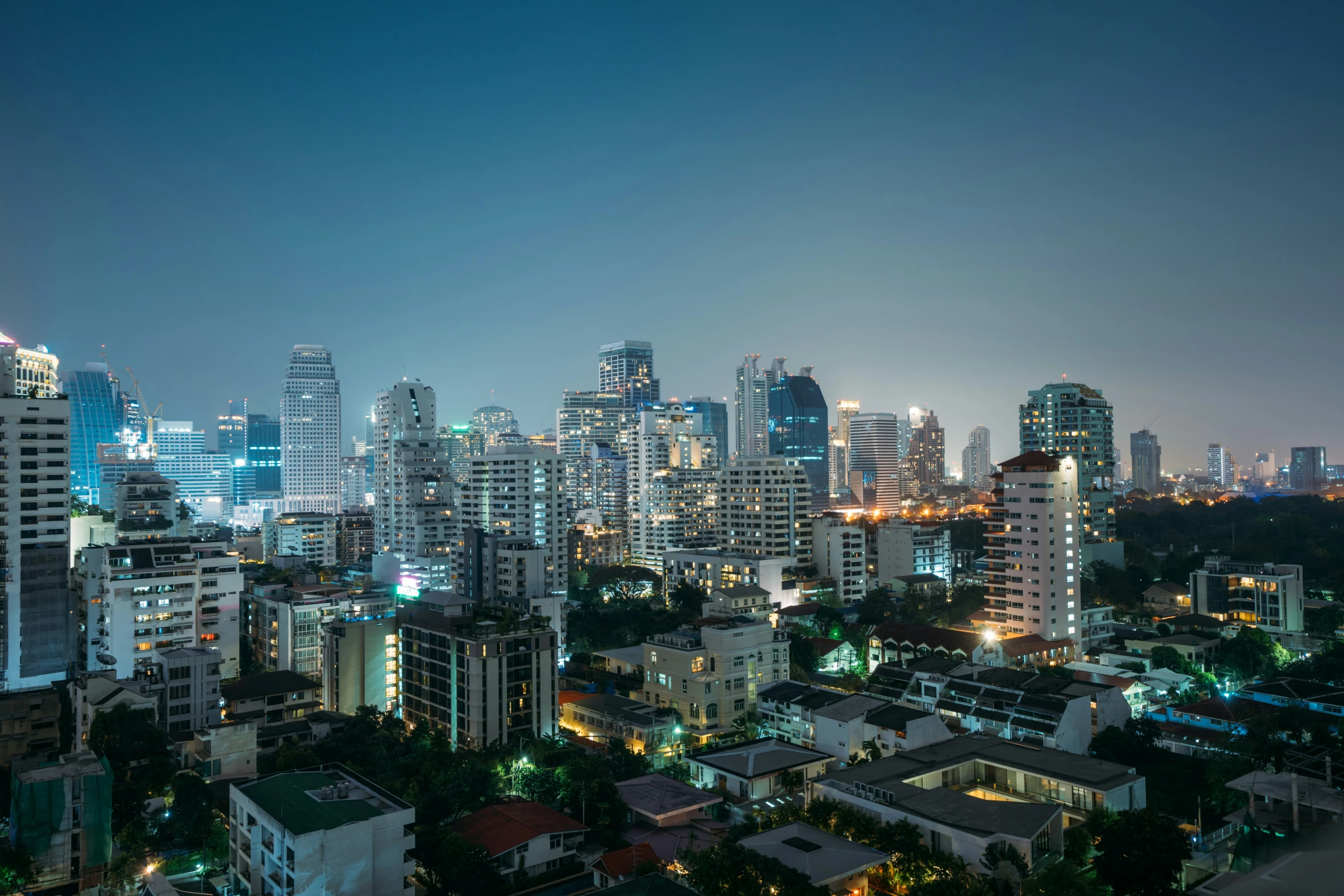 an aerial view of several city buildings at night