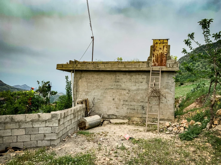 a building with a ladder in the wall on top of it