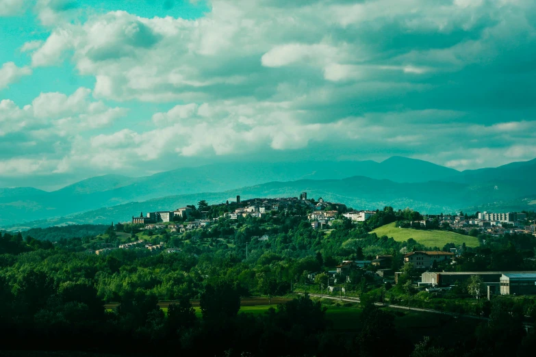 a green city with trees on a hillside