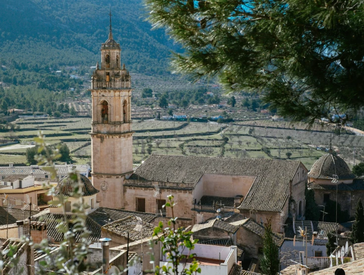 a view of the town and hills with trees on them